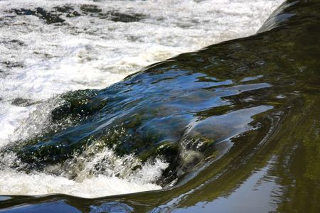 Water flowing over rocks in a river stream at Old Graud Mill in Chicago.の写真素材