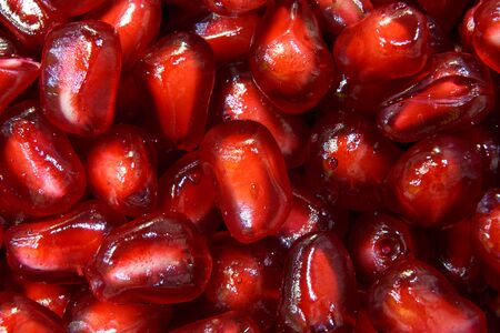 Juicy ripe,delicious red garnet stylish closeup, pomegranate, splashes, water drops.の写真素材