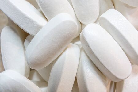 White oblong pills. Macro close-up shot.の写真素材