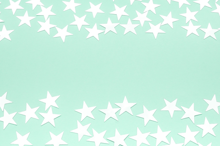 Silver stars on a neo mint background. Festive holiday pastel backdrop. Neo mint color 2020 year concept. Copy space. Flat lay.の写真素材