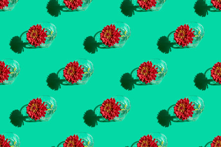 Seamless pattern of a glass with water and deep red flower Dahlia on green background. Minimal...