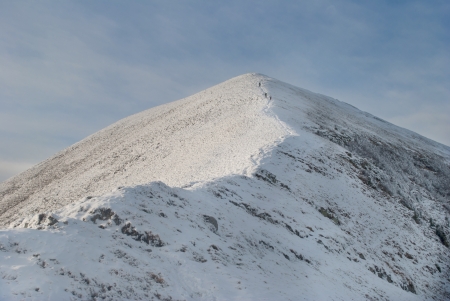 landscape of snowy mountain with footpaith on peakの写真素材