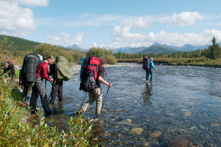 hikers crossing mountain river, Ural, Russiaの写真素材