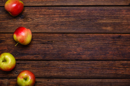 Fresh organic red apples on wooden table close-upの写真素材