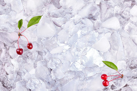 background with fresh cherry on ice cubes, top view