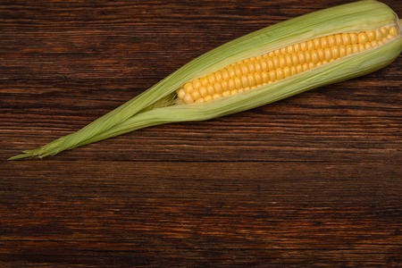 Fresh corn on the wooden table closeup, top view horizontalの写真素材