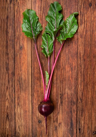 fresh beetroot with leaves on white wooden, top viewの写真素材
