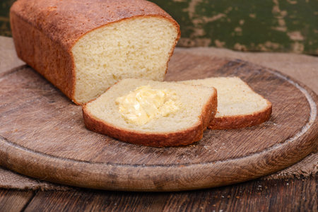 Sliced baked white bread on wooden board table