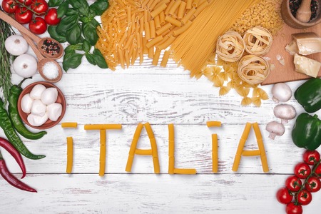 Italian pasta ingredients on white wooden table, top view, copy spaceの写真素材