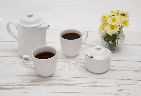 teatime cups of tea on wooden white tableの写真素材