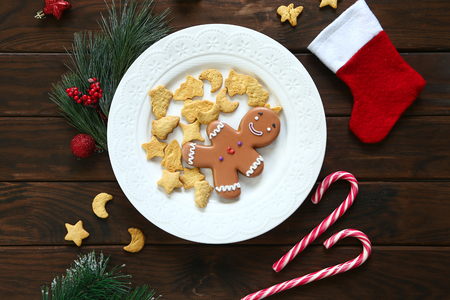Plate with tasty gingerbread cookies on wooden table, close up viewの写真素材
