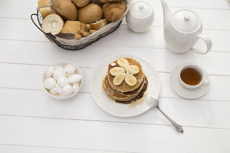 breakfast with pancakes and tea on tableの写真素材