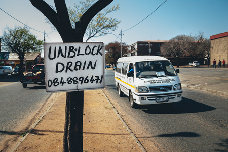 Johannesburg , Gauteng / South Africa - October 20 2018 :  african taxi with passengers driving past tree sign midday rosettenville johannesburgのeditorial素材