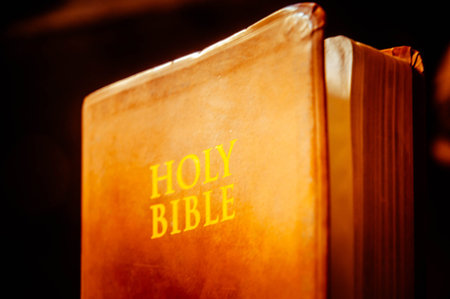 Holy Bible on a dark background. Selective focus. Shallow depth of field.