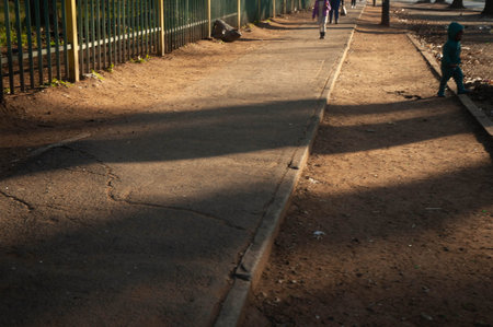 Children walking in the park on a sunny day.