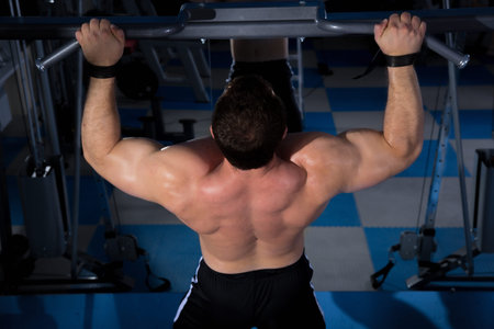 beautiful, powerful, strong man posing at the gym