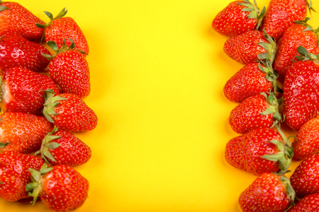 Fresh strawberry in on a yellow background.の写真素材