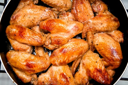 Closeup of baked chicken wings in baking pan. Selective focusの写真素材