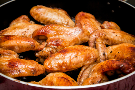 Closeup of baked chicken wings in baking pan. Selective focusの写真素材