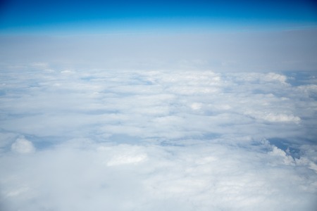 Clouds and sky as seen through window of an aircraftの写真素材