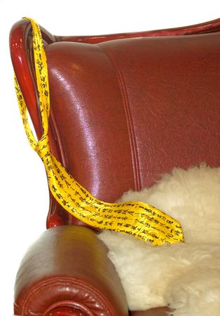 yellow tie hanging from the back of the chairの写真素材