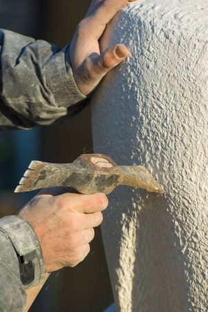 Stonecutter carves with a pick sculpture of limestoneの写真素材