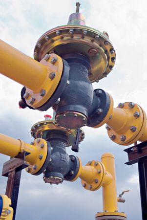 yellow gas pipe with a crane and gear の写真素材