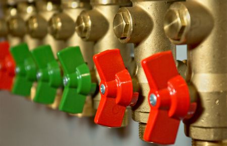 Compact brass distributor with red valvesの写真素材