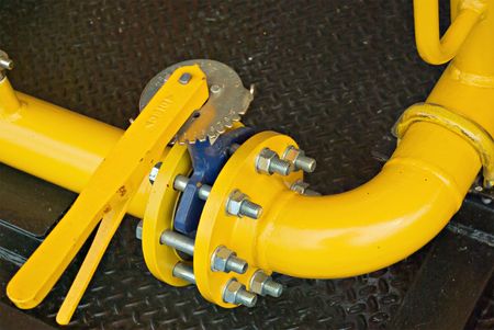 yellow gas pipe with a crane and gear の写真素材
