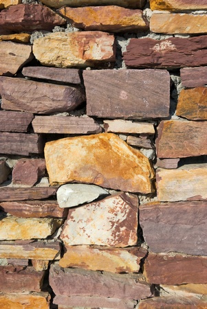 Laid-old wall of granite stones close upの写真素材