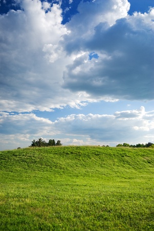 Landscape - green fields, the blue sky and white cloudsの写真素材