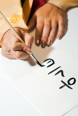 Korean girl write the word on paper close upの写真素材