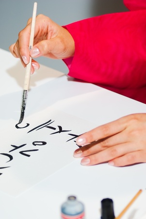 Korean girl write the word on paper close upの写真素材