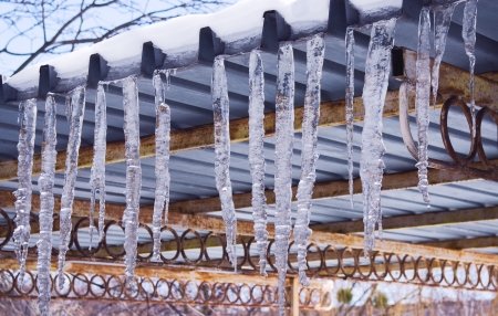 The icicles which are hanging down from a roofの写真素材