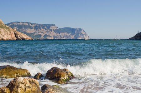 Sea waves lapping on the rocksの写真素材