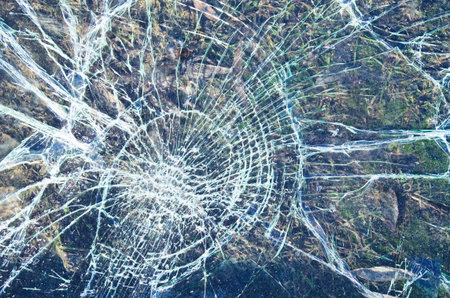 Broken glass over grey .