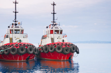 A red tugboats are moored in the harborの写真素材