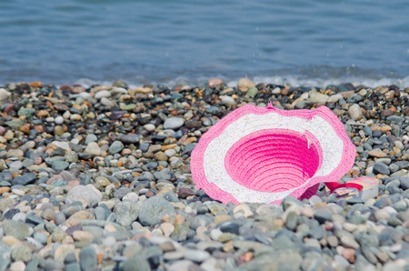 beach hat lying on the rocksの写真素材