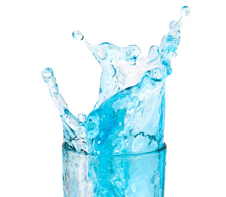 ice cubes threw into a glass of pure water and water splashes. Isolated on a white background