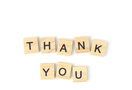 Top view, Thank you for the alphabet on the wooden tile pieces scraped square. Isolated on white backgroundの写真素材