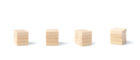 The wooden blocks are stacked in layers with geometric shapes on each side. isolated on a white backgroundの写真素材