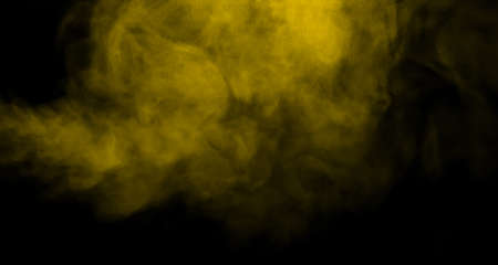 swirling movement of the yellow-gold smoke group, abstract line Isolated on black backgroundの写真素材