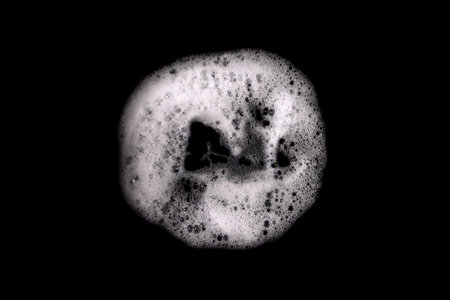 Top view, liquid white foam from soap or shampoo or shower gel. Abstract bubbles. isolated on a...