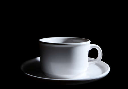 white ceramic cup. isolated on a black background. with copy space for adding textの写真素材