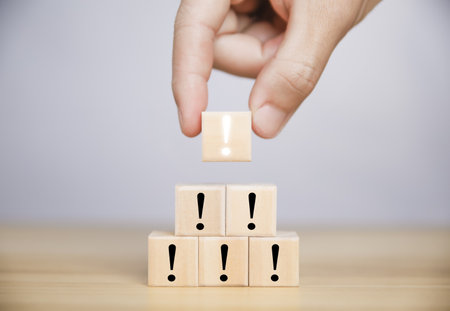 The wooden block shows a black and white exclamation mark. business development ideas Error warning, notification, maintenance, and finding solutions. with copy spaceの写真素材