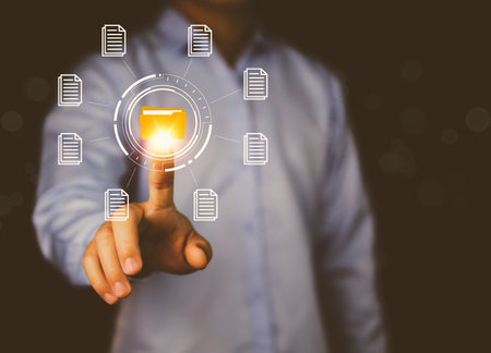 Businessman hand showing electronic document management icon. Concept of efficient access to a corporate business online document database. Internet file system Paperless office on digital technologyの写真素材
