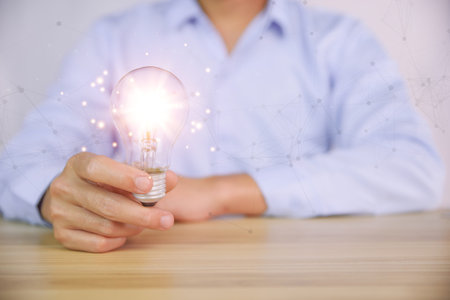 businessman holding a light bulb graphic Digital technology abstract. imagine an idea Creative and...