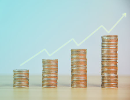 businessman analyzes and calculates stock financial indices. Stacking coins is growing. Ideas to saving money in a bank account and investing in funds to maximize profits from business investmentsの写真素材