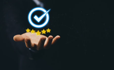 Businessman hand showing digital technology icon sign with a check mark. The best quality assurance...