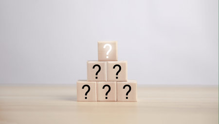 A wooden cube block showing a question mark icon. concept alternative thinking, ideas, confusion,...